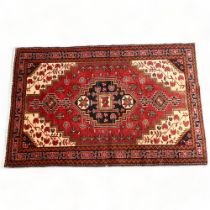 A Hamadan handmade red ground geometric design rug, 194cm x 103cm