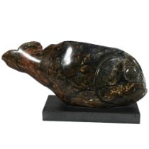 A carved and polished green/black marble fish on black granite base, length 41cm