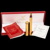 CARTIER - a gold plated ballpoint pen, boxed