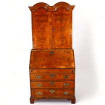 A Queen Anne Period bureau bookcase, elm and burr-elm, double dome-shaped pediment, the 2 upper