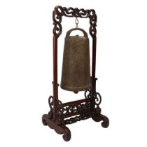 A Chinese bronze bell on carved and pierced hardwood stand, height 46cm Repaired damage to the top