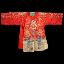 A Chinese red silk jacket with colourful embroidered and gold braid dragons