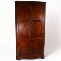 A large Georgian oak corner cupboard, with interior painted shelves and slide, 205 x 105cm