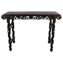 A Chinese 19th century hardwood altar table, with carved and pierced frieze, raised on end supports,