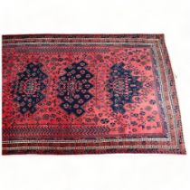 A hand-made Kurdish red and blue ground geometric design rug, mid to late 20th century, 290 x 182cm