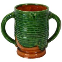 Edwin Beer Fishley for Fremington Pottery Devon (1832 - 1911), a green glazed 2-handled loving