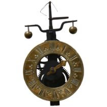 A wall-hanging gravity clock, engraved brass chapter ring with iron movement, together with weights,