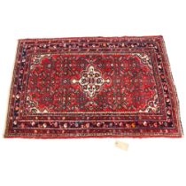 A North West Persian red ground wool rug, 152 x 104cm