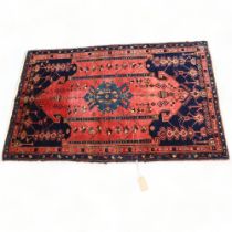 A mid-20th century Caucasus Shirvan red and blue ground wool rug, 185 x 115cm