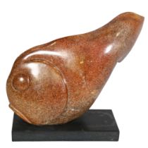A carved and polished red/brown granite fish on black granite base, length 33cm