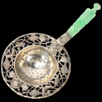 A Chinese silver tea strainer, with relief carved jade handle, length 17cm, in original fitted box