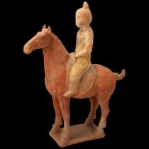 A Chinese Tang style terracotta horse and rider, height 31cm