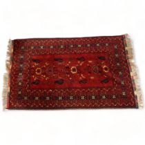 A Persian handmade red ground wool rug, 205cm x 125cm