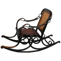 A late 19th century Thonet No 3 rocking chair of unusual form, the ebonised bentwood frame with