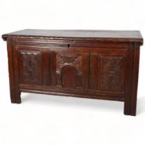 A 17th century oak panelled coffer, with chip carved Archadian and linenfold panels, 120 x 54 x 66cm