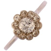 An early 20th century platinum diamond flowerhead cluster ring, set with old European and single-cut