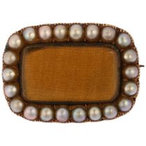 A Georgian pearl cluster mourning brooch, circa 1830, the central convex glass covered moire silk