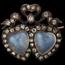 A Victorian moonstone and diamond twin heart brooch, circa 1890, each set with a heart cabochon