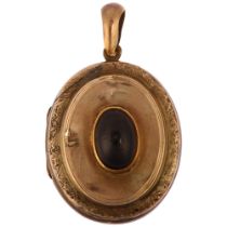 A Victorian garnet locket pendant, circa 1890, unmarked yellow metal settings with central oval