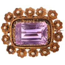 A Victorian amethyst floral brooch, circa 1860, unmarked gold settings, with 11.5ct modified