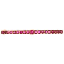 A Victorian ruby line bar brooch, unmarked gold settings, pave set with round-cut rubies, 51.8mm,