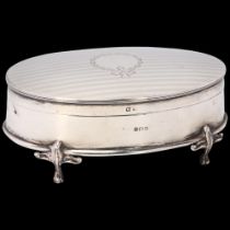 A George V silver dressing table jewel box, indistinct maker, Birmingham 1910, oval form with engine