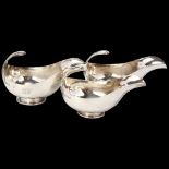 HARRODS - a graduated set of 3 George V silver sauce boats, London 1934, stylised form with floating