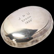 A George V silver tobacco box, George Unite, Birmingham 1927, oval form with squeeze action lid,