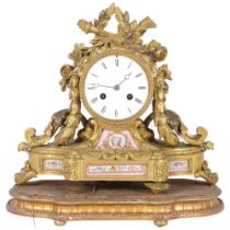 An ornate 19th century gilt-bronze mantel clock, an 8-day striking movement, and ceramic panels,