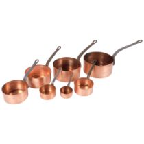 A graduated set of 7 French copper saucepans with iron handles