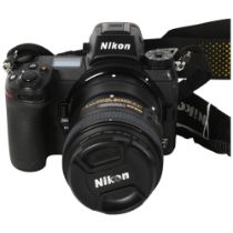 A Nikon ZX digital camera, with Nikon AF-S Nikkor 50mm 1:1.8G zoom lens, a Nikon battery charger
