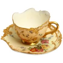 A Royal Worcester Blush Ivory Empress tea cup and saucer, decorated with sprays of flowers, with