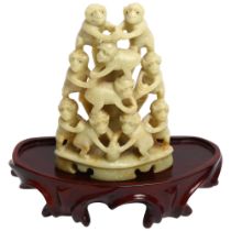 A Chinese carved soapstone group of monkeys on wood stand, overall height 14cm