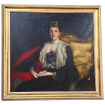 A large Victorian oil on canvas, portrait of a lady seated on an armchair, script to the bottom