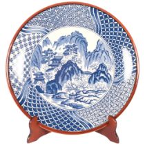 A large Chinese blue and white charger, with brown glazed rim, diameter 38cm, with stand Good