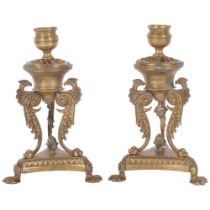 A pair of 19th century Empire style brass candlesticks, phoenix supports, the sconces loose