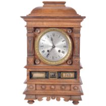An unusual walnut-cased calendar mantel clock, with silvered dial and 8-day gong striking