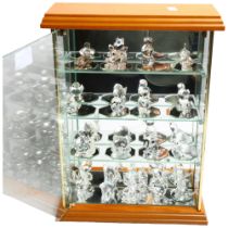 A collection of miniature Swarovski glass animals (19), in a table-top display cabinet, cabinet