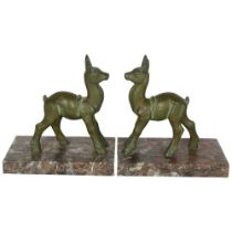 A pair of Art Deco Faun verdigris metal bookends on marble plinths, H16.5cm