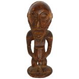 An African carved wood fertility figure, 25cm