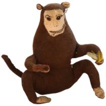 A Vintage soft-filled felt-covered monkey