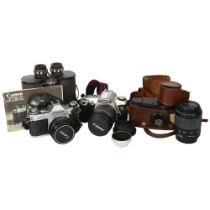 A Canon AE-1 associated Canon 50mm lens, a Canon EOS500N, and associated Canon zoom lens EF28-