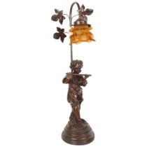A composition table lamp supported by cherub musician, with amber glass shade, 65cm