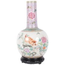 A large Chinese famille rose bottle vase, enamel decoration depicting a prowling cat, on carved