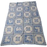 A large blue and white hand sewn cross stitch table cloth, table cloth is made up of 24 squares hand