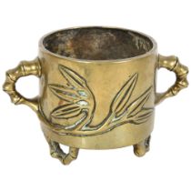 A Chinese bronze 2-handled pot on 3 faux bamboo feet, with 6 character mark, H9cm