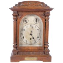 A circa 1930s oak-cased mantel clock, with an engraved and embossed dial, 8-day striking movement