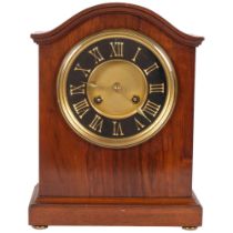 An early 20th century walnut-cased dome-top mantel clock, with 8-day bell striking movement, black