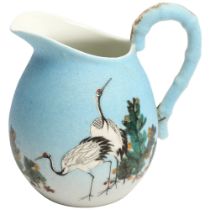 A Japanese porcelain jug with painted cranes, signed under base, height 13cm Handle restored