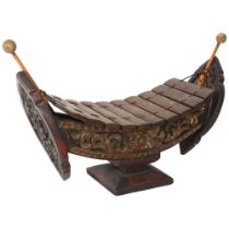 A "Ranat Ek", a wooden xylophone in the shape of a sailing ship, likely from Thailand, with